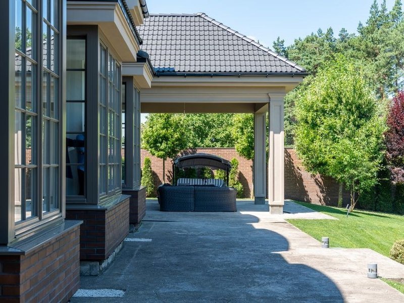 Terrasse d'un pavillon de la plaine de Chaponnay carrelée en carreau d'extérieur devant la baie du séjour