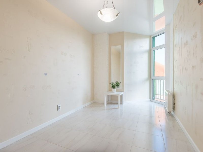 Pose de carrelage grand format clair au sol d'un appartement récent de Gerland à Lyon 7 sur une chape saine