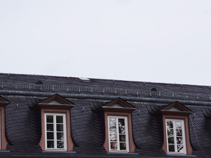 Lucarne sur la toiture ancienne d'un immeuble du Vieux-Lyon, joue et noue à reprendre avant réfection