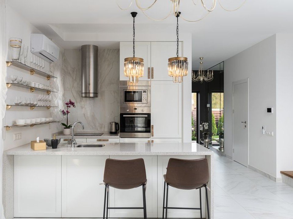 Cuisine neuve installée dans un appartement récent livré nu à Décines, meubles posés sur les attentes eau et électricité du promoteur, plan de travail continu ouvert sur le séjour d'une résidence neuve