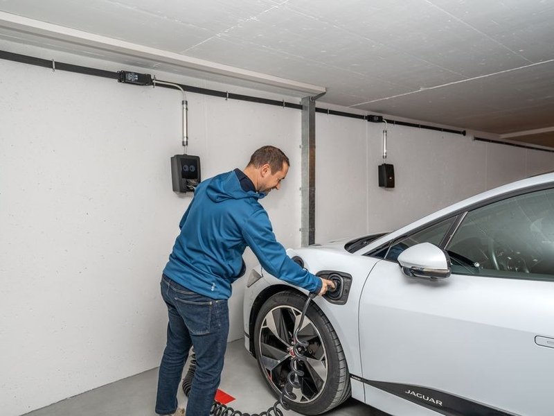 Borne de recharge pour véhicule électrique installée dans le garage d'une villa à Écully, alimentée par un circuit dédié
