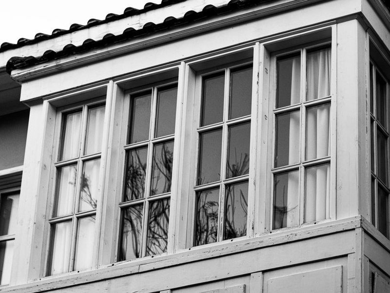 Ancienne fenêtre en bois à petits carreaux d'une maison du bourg-centre de Brignais avant restauration