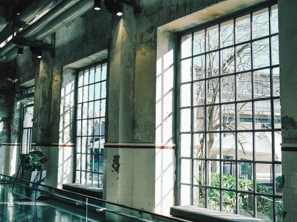 Menuisier restaurant une très grande fenêtre bois de près de quatre mètres de haut dans un ancien atelier de canut baigné de lumière à la Croix-Rousse à Lyon 4e