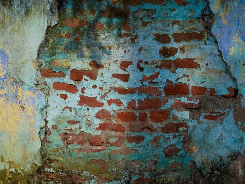 Mise en peinture mate d'un mur irrégulier en pisé enduit de plâtre dans un logement des pentes de la Croix-Rousse à Lyon 1er, bâti ouvrier ancien