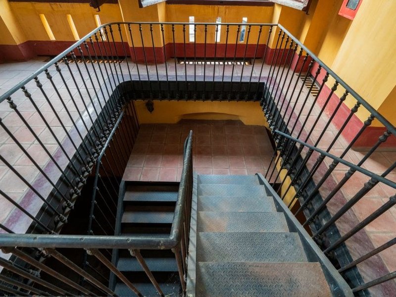 Cage d'escalier commune d'une petite copropriété modeste à Saint-Fons repeinte en teinte claire avec une finition lessivable résistante au passage