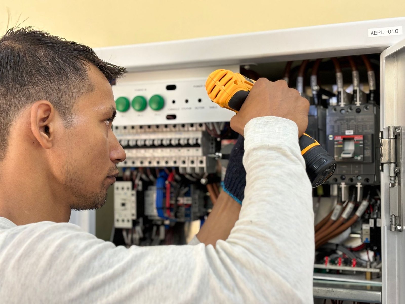 Électricien câblant un tableau électrique pour ajouter des circuits à Lyon